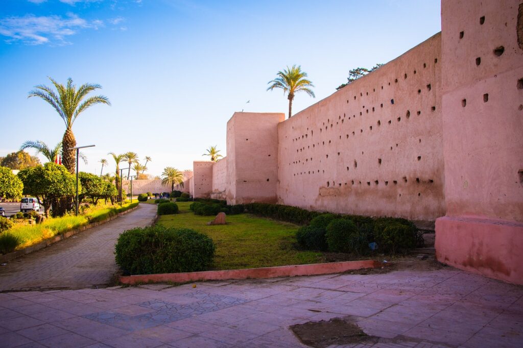 Une grande muraille de couleur ocre rosé s'étend à travers l'image sous un ciel bleu clair. C`est ce que vous pouvez remarquer dans un Voyage au Maroc. Mais il y`a une Liste Indispensable pour Préparer Votre valise 